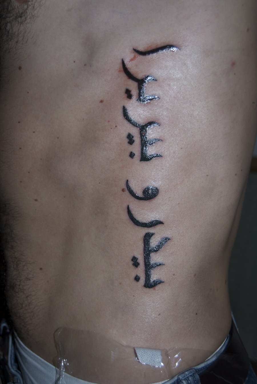 cursive tattoo font on ribs