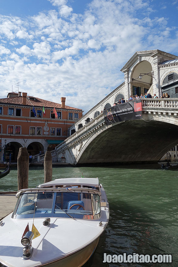 Boat taxi and the Rialto Bridge or Ponte di Rialto spanning the Grand Canal in Venice
